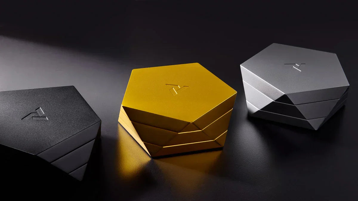 A trio of Vesta designer ashtrays shown in black Abyss, gold Radiance, and silver Mercury