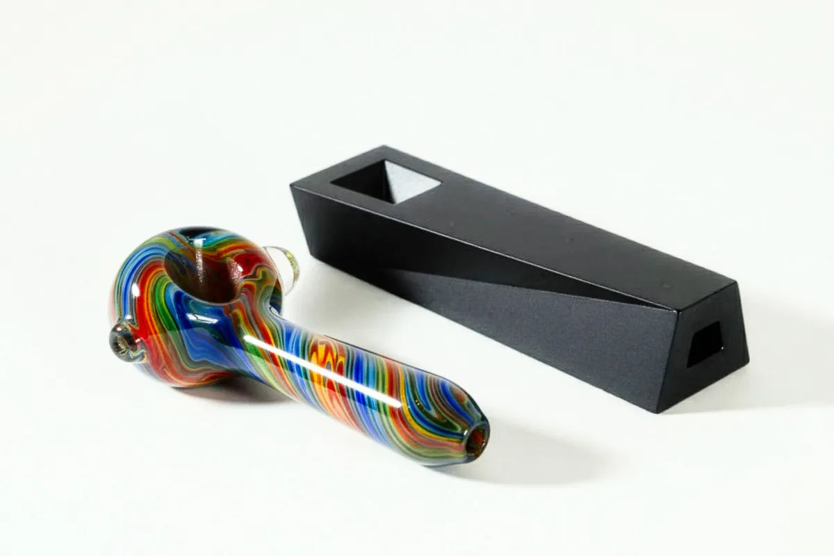 a classic glass spoon pipe next to a modern designer metal pipe