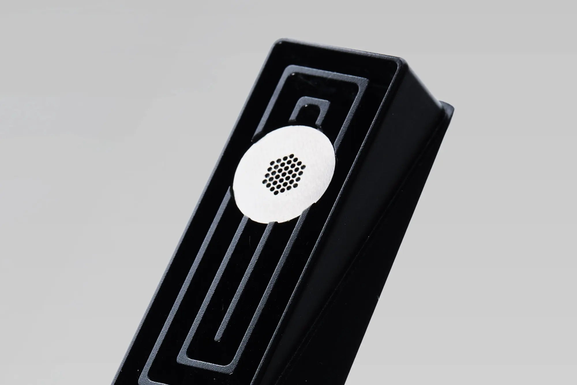 Tempest modern smoking pipe with pure titanium filter shown resting above the labyrinth cavity